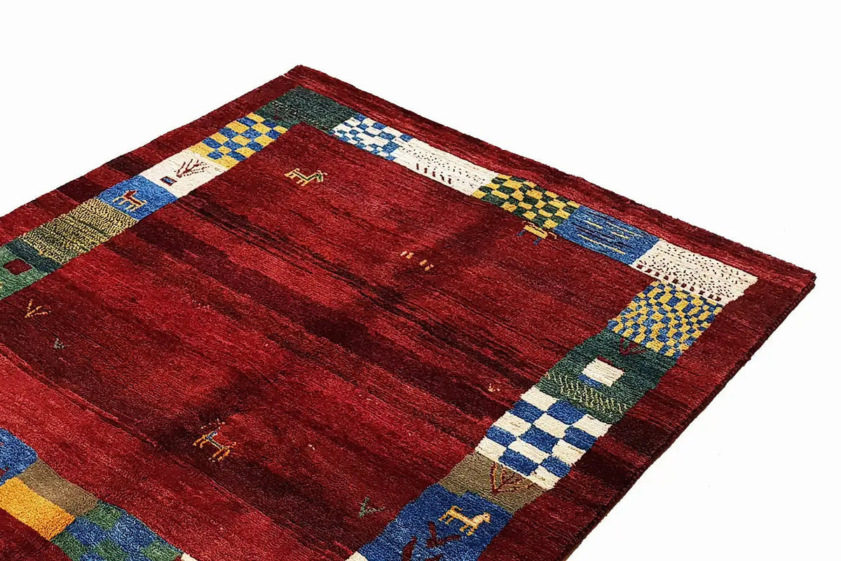 Gabbeh rug with a red striped pattern and colorful border of checkered squares