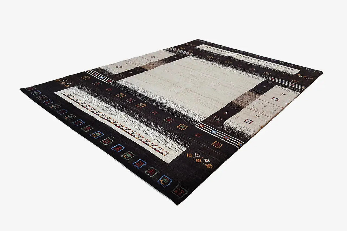 Rectangular Gabbeh rug laid flat: dark border with patterned stripes in black/beige
