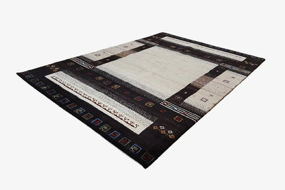 Rectangular Gabbeh rug laid flat: dark border with patterned stripes in black/beige