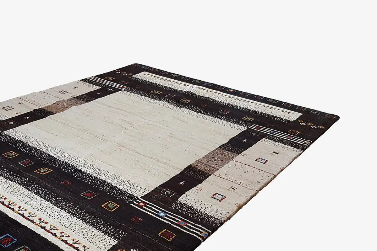 Gabbeh rug with a light center and dark border stripes, small ornaments along the edges
