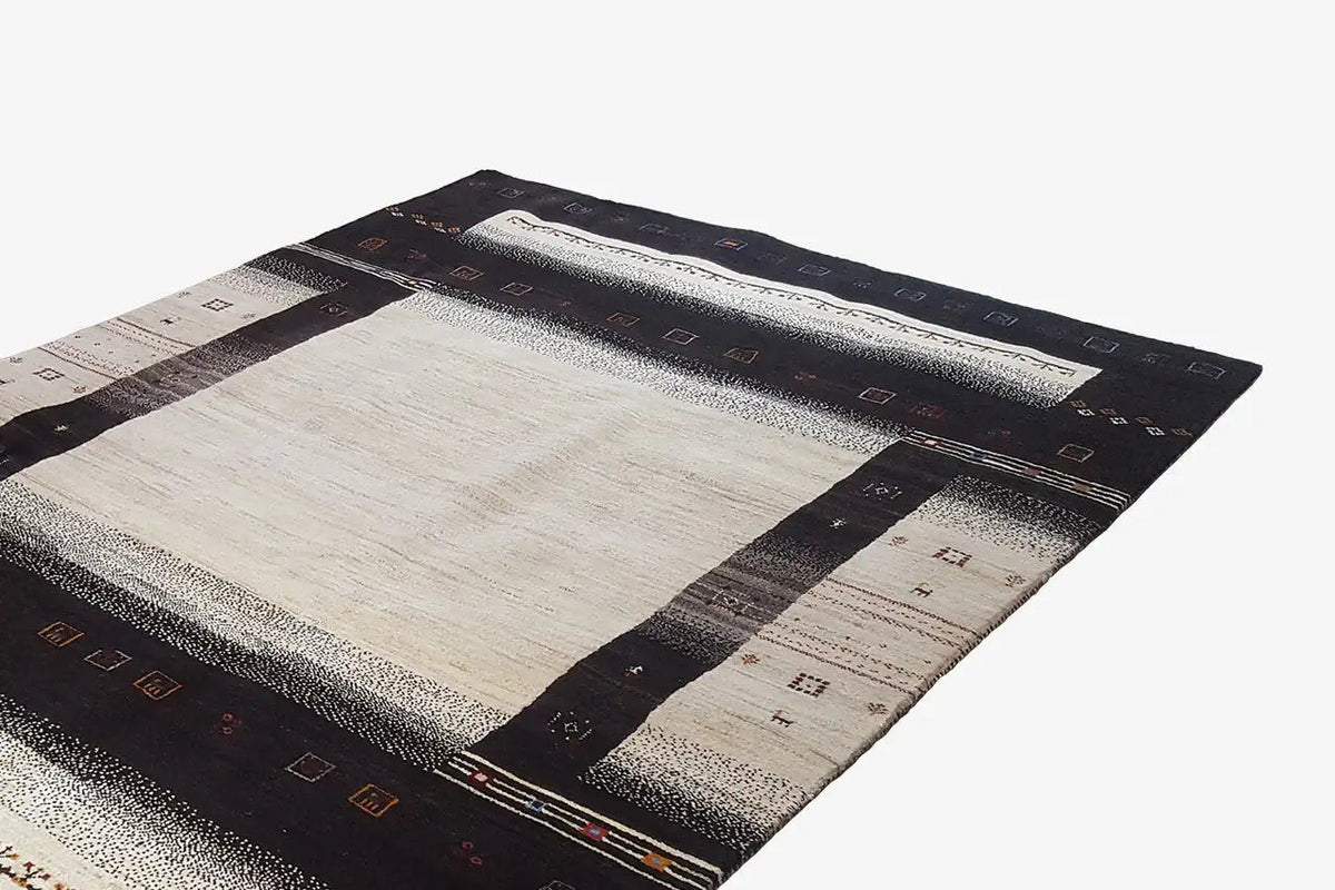 Gabbeh rug (303x201 cm) in black-brown with a beige square and block-pattern border