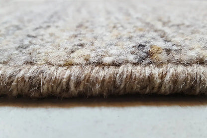 Close-up of a Gabbeh rug edge with a dense pile in light gray and beige tones