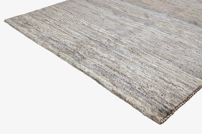 Gabbeh rug, photographed at an angle, heathered flat weave in natural gray