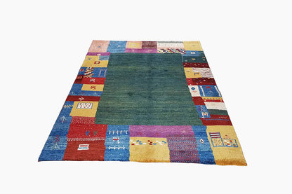 Gabbeh rug in a rectangular shape: dark green center, colorful border panels