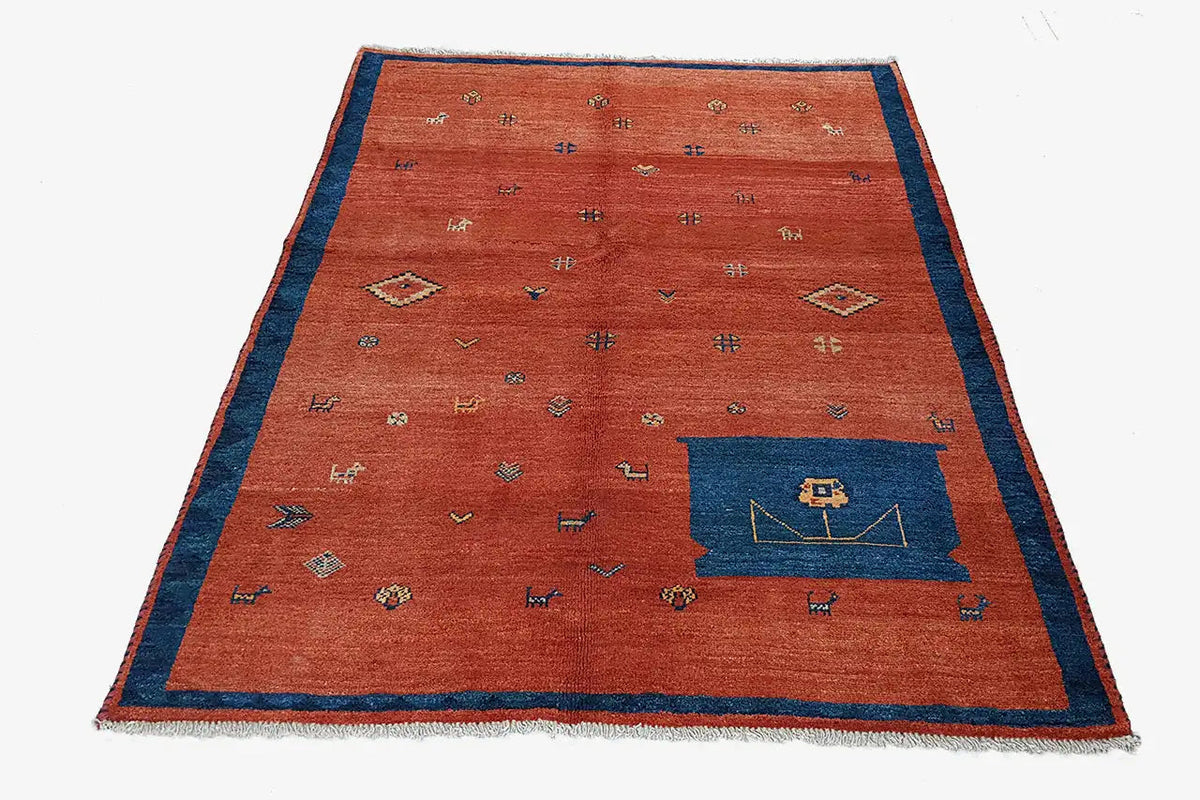 Red carpet with a blue border, many small patterns, and a dark blue corner section, fringes