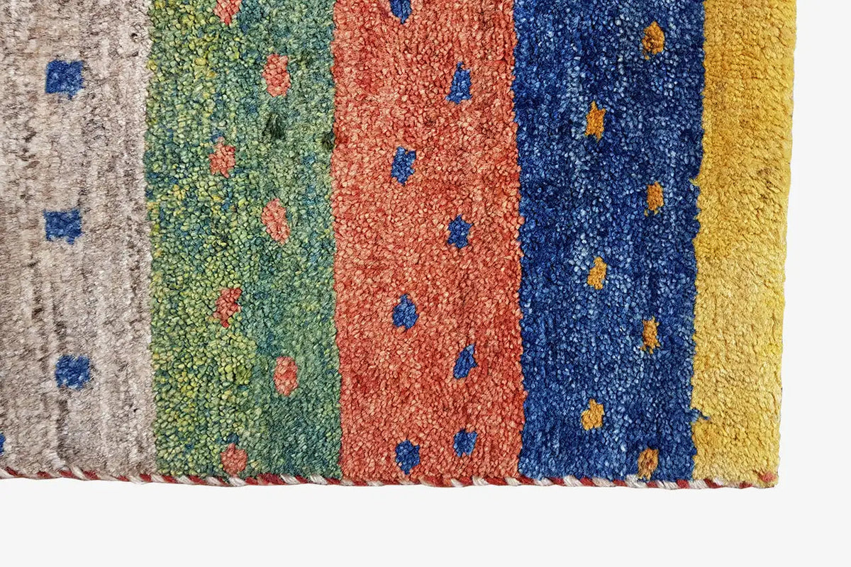 Gabbeh rug close-up of the pile height: multicolored stripes with dot patterns