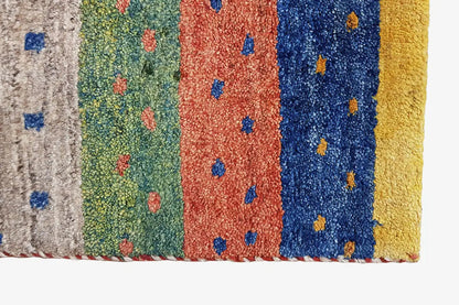 Gabbeh rug close-up of the pile height: multicolored stripes with dot patterns