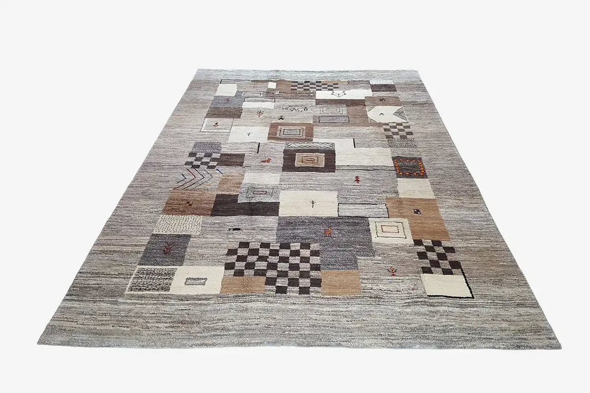 Rug with an all-over patchwork pattern of squares and diamonds in light and dark shades of gray