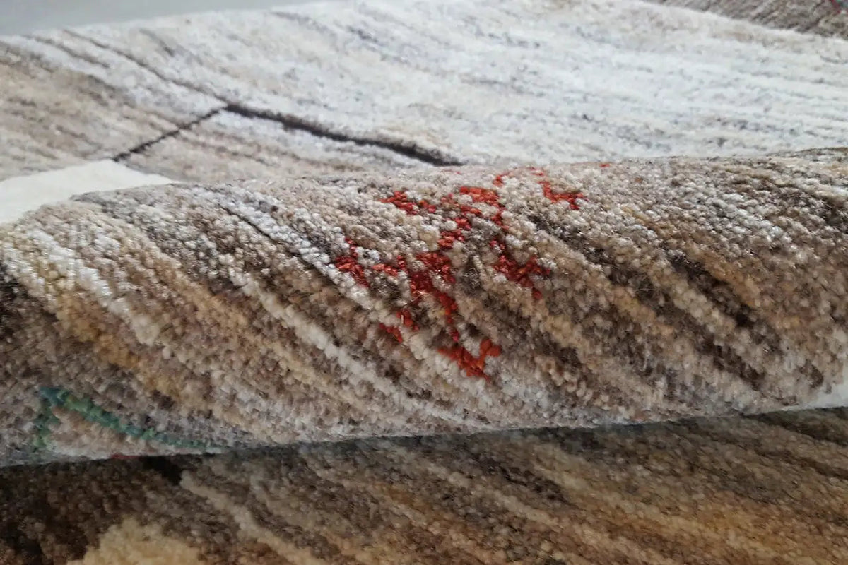 Carpet pile with a textured surface and red, multicolored accents