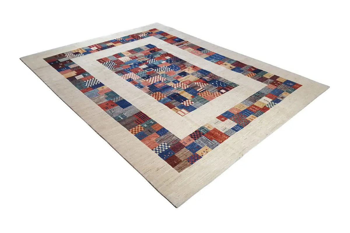 Pure wool rug with patchwork border and central motif in blue, red, beige