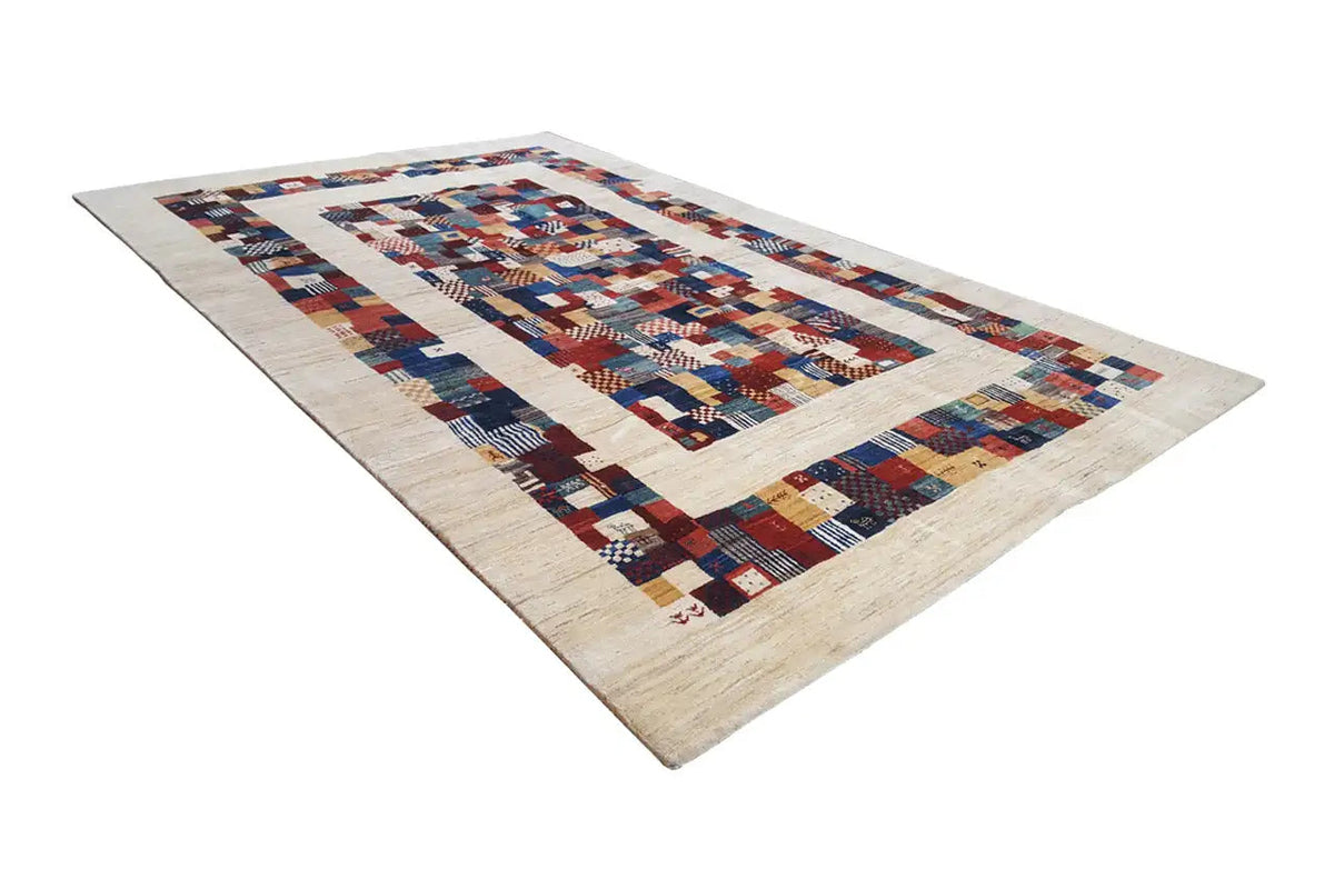 Gabbeh rug with a geometric patchwork border, shades of blue and red on a light background
