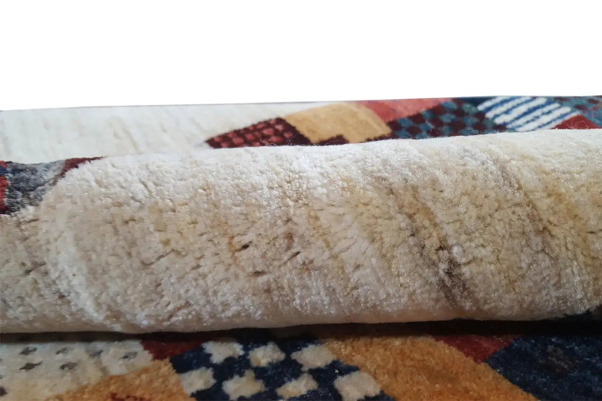 Gabbeh rug: close-up of the wool pile at the edge with multicolored patchwork