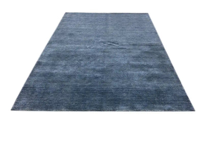 Blue rug with a dense, mottled weave, rectangular shape