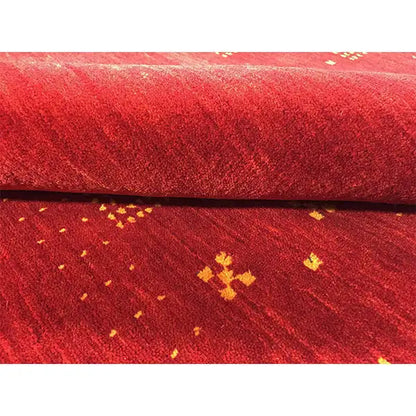Reddish-brown Gabbeh rug with detailed golden pattern dots, short pile