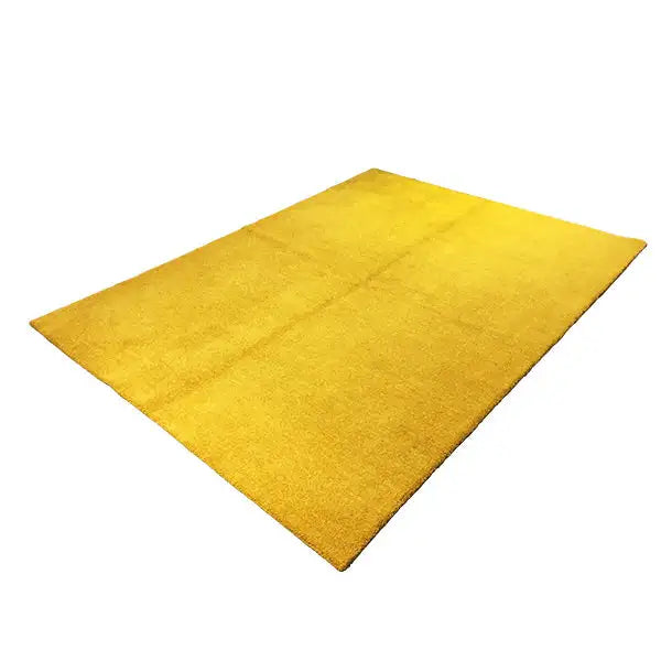 Mustard-yellow gabbeh rug, viewed at an angle, fine pile texture, rectangular