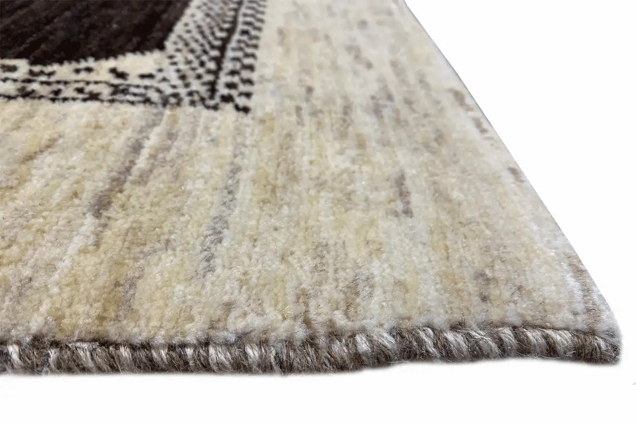 Gabbeh rug detail: fluffy wool edge with a thick fringed border