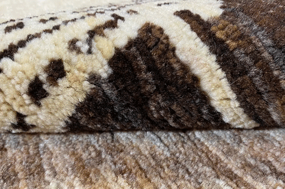 Gabbeh rug detail: woven texture with dark and beige ornamental panels