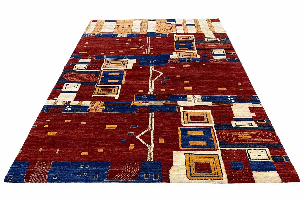 Gabbeh rug with a red background, blue border motifs, and beige-white squares
