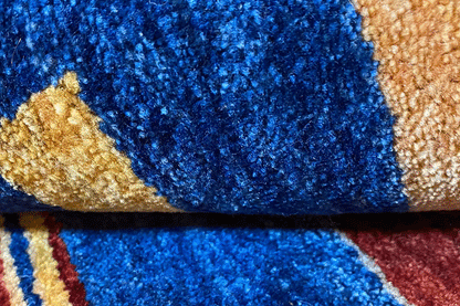 Gabbeh rug detail: blue and beige pile stripes, dense wool weave