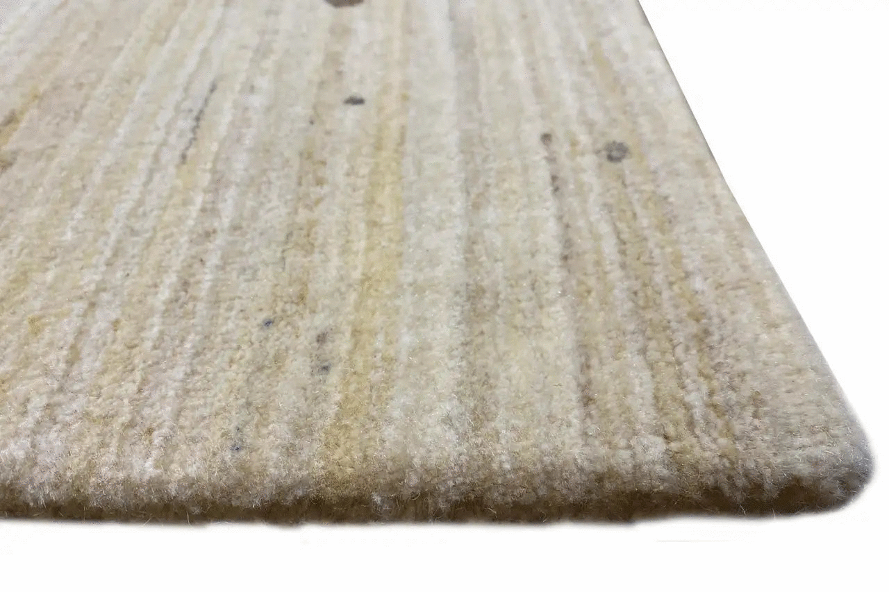 Close-up of a Gabbeh rug: light pile surface with a fine, even thread texture