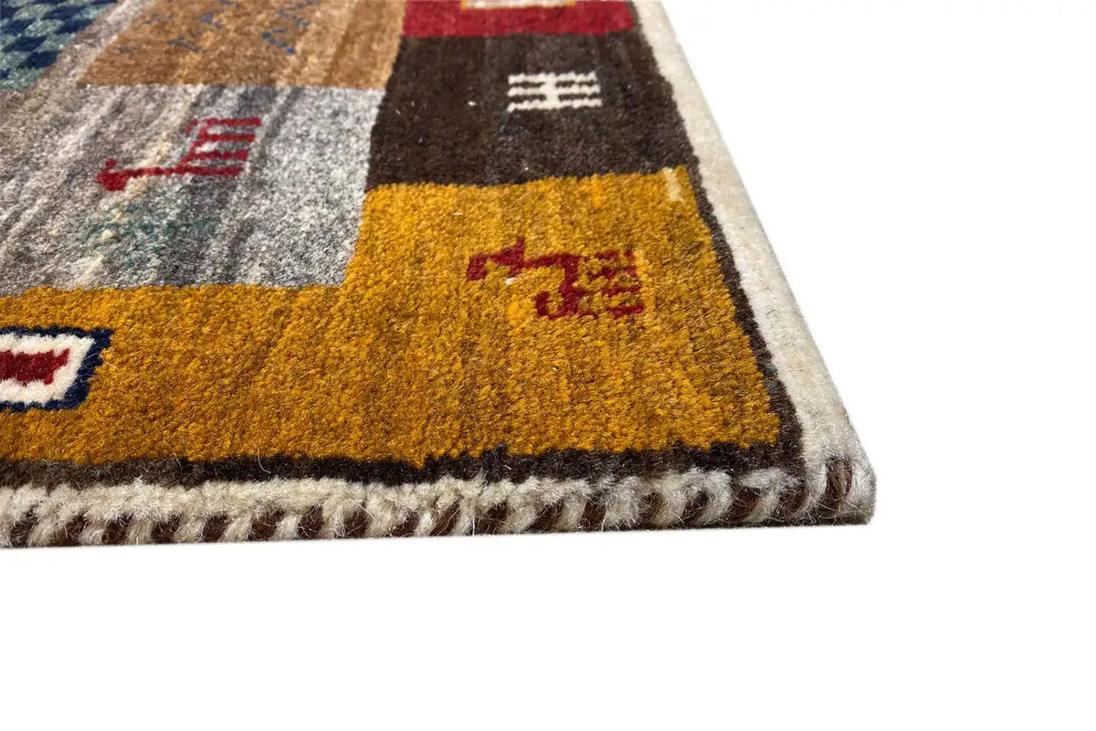Gabbeh rug detail: pile texture and bound edge with yellow rectangle