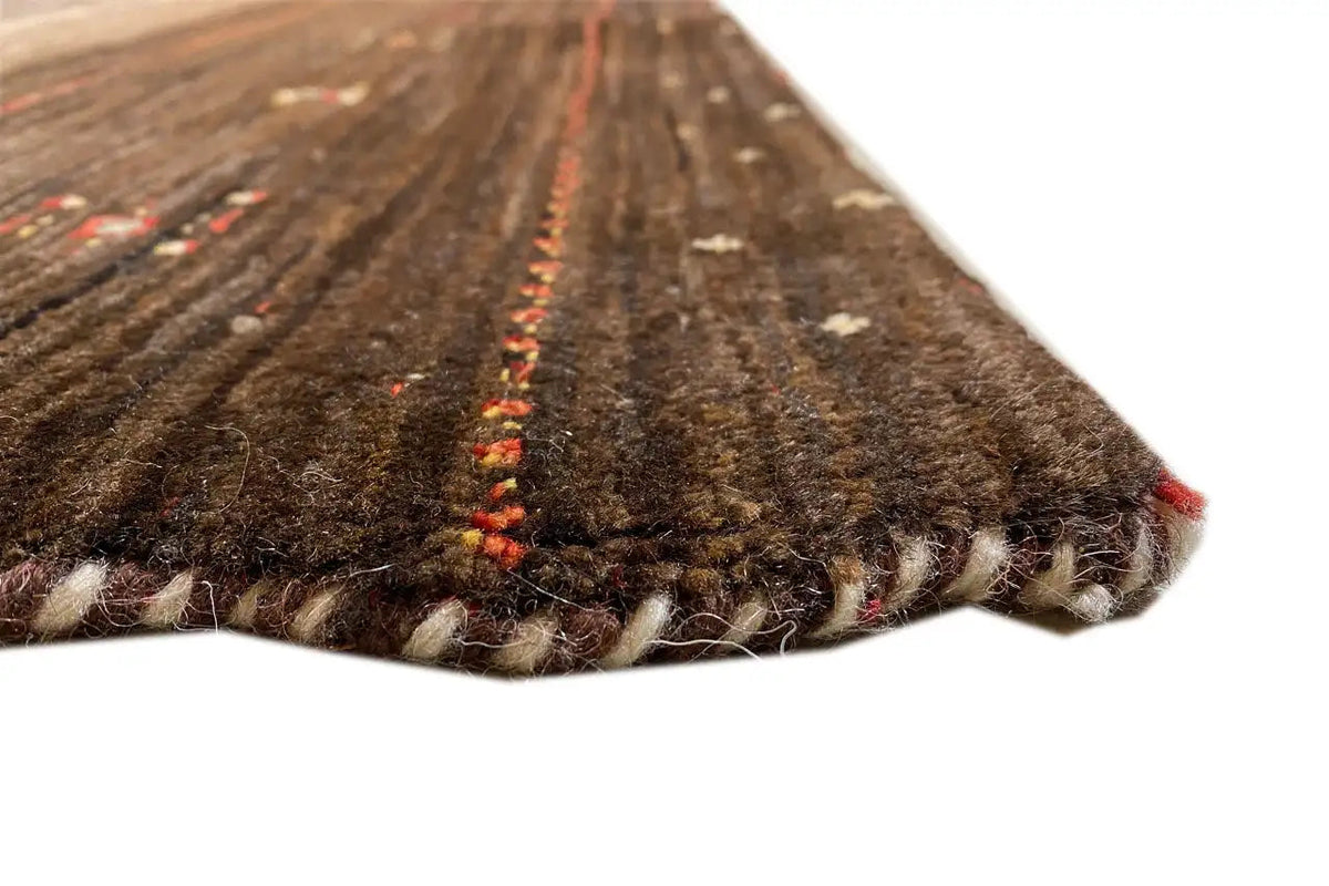 Carpet edge in detail: dark brown pile with red color accents