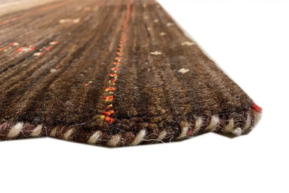 Carpet edge in detail: dark brown pile with red color accents