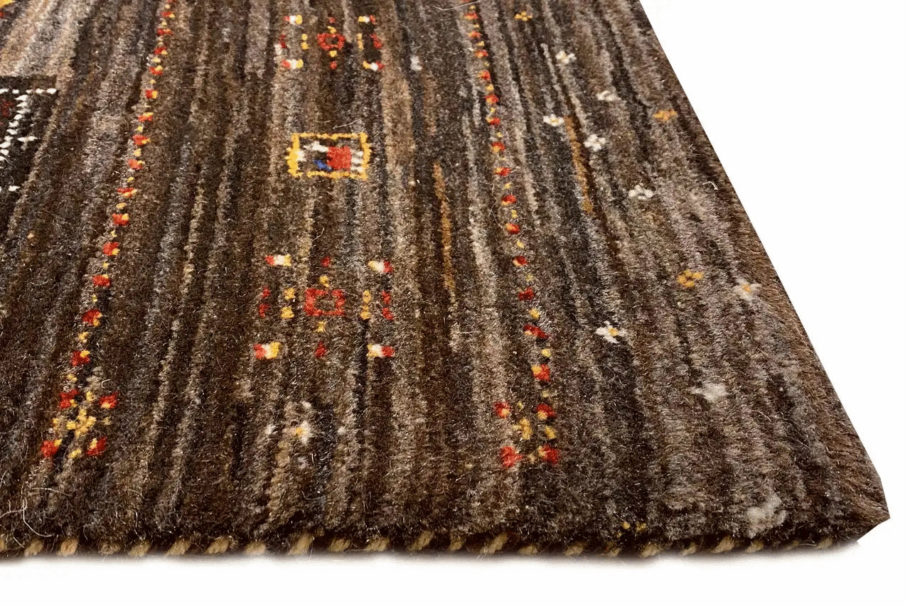 Rug with dark pile, vertical lines, and colorful yellow and red ornaments
