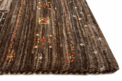 Rug with dark pile, vertical lines, and colorful yellow and red ornaments