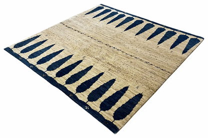 Gabbeh rug with a beige background and dark blue vine lines in a block pattern