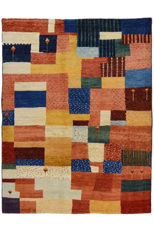 Patchwork rug with geometric blocks in blue, red, yellow, and cream, flat-woven