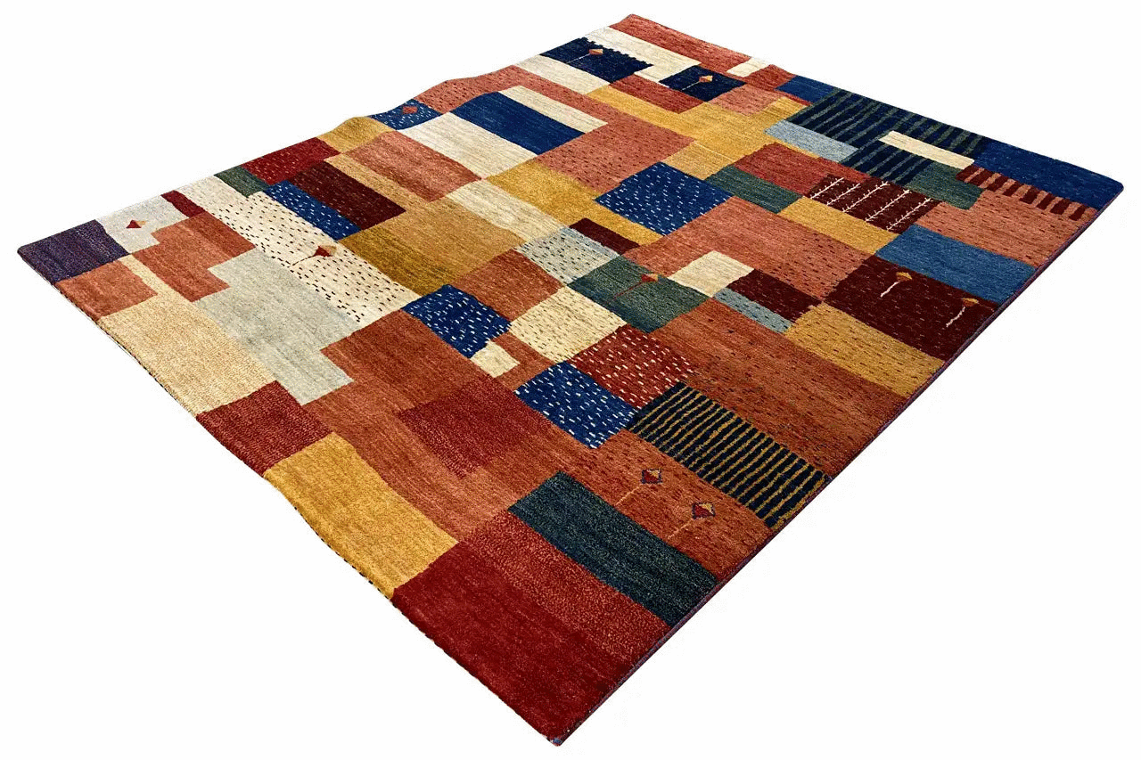 Geometric patchwork rug with checkered and block patterns in warm red and blue tones