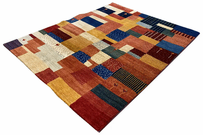 Geometric patchwork rug with checkered and block patterns in warm red and blue tones