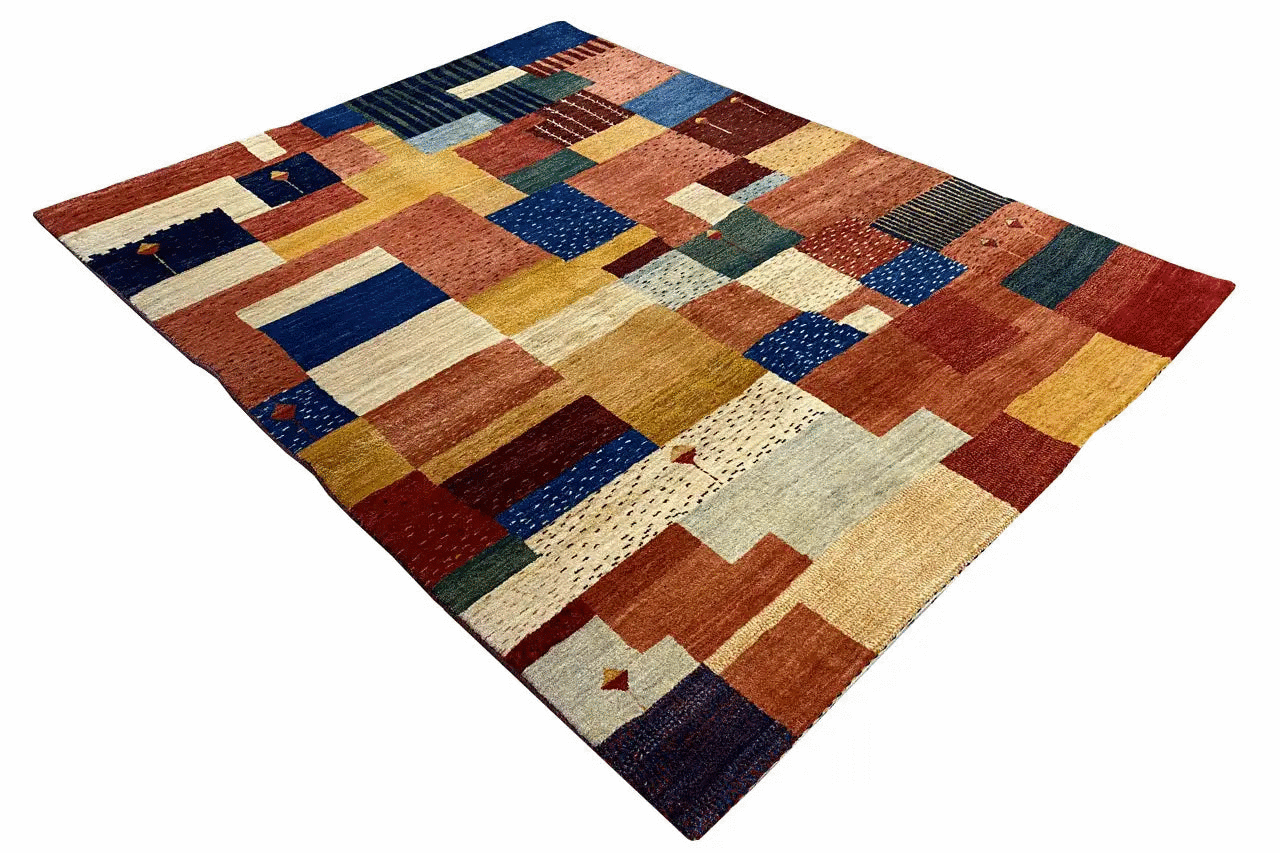 Oblique view: patchwork rug with colored rectangles and a blue and red border
