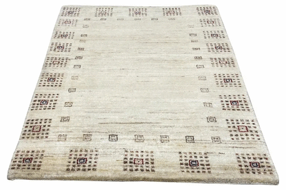 Gabbeh rug 94x64 cm in light beige with a regular geometric pattern
