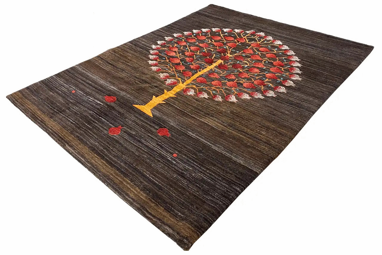 Dark brown rug with a round tree motif in red, yellow, and white details