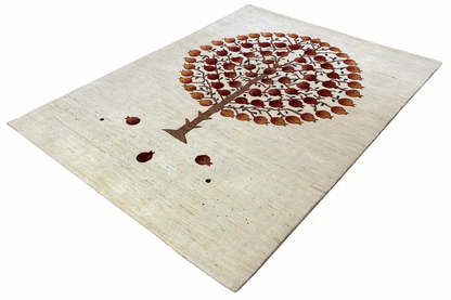 Gabbeh rug at an angle: tree with round crown points in brown-red on a light background