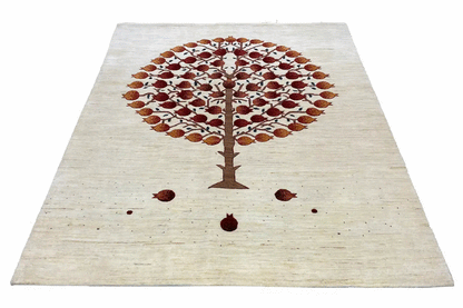 Gabbeh rug with a centered tree motif, light-colored field with brownish-red dots and fine speckles