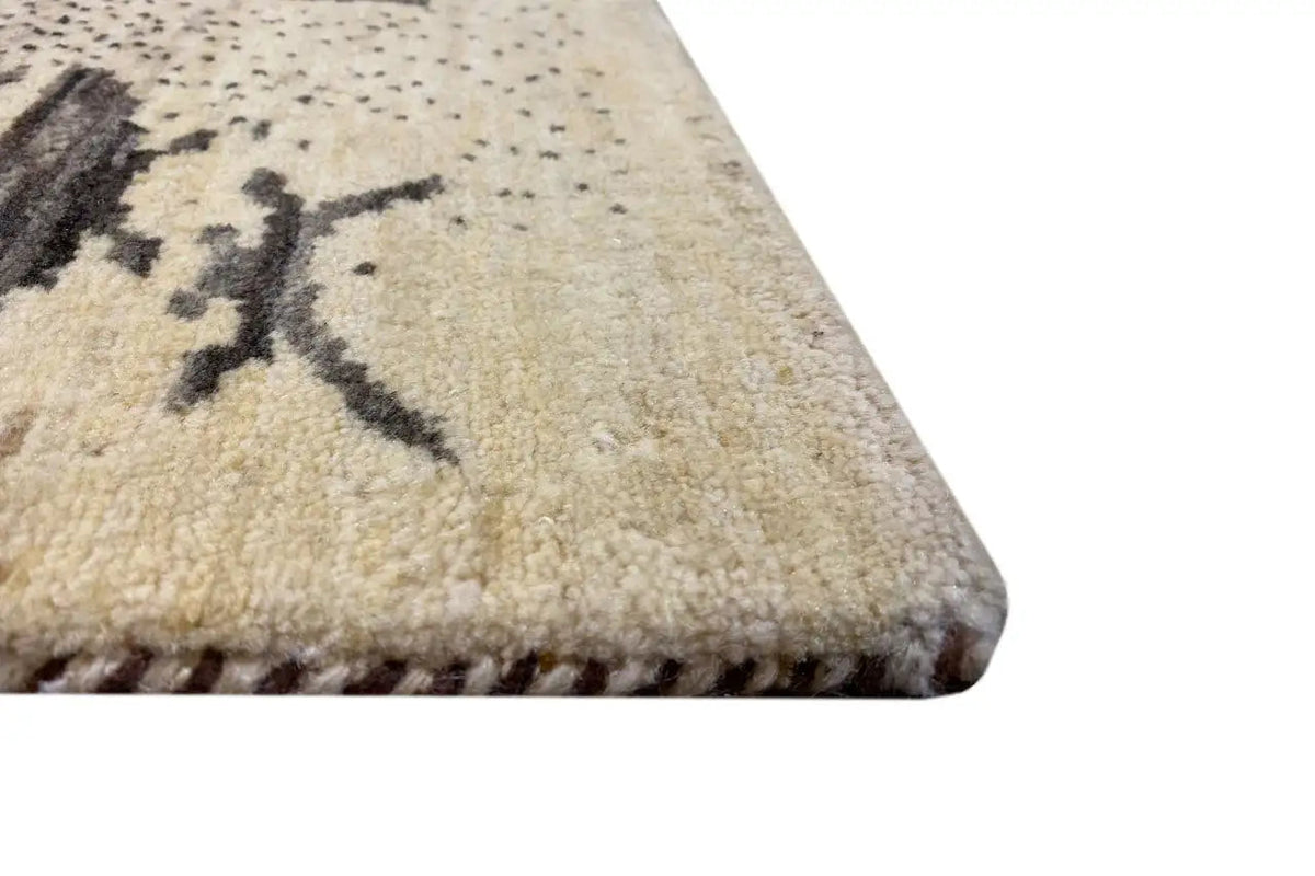 Close-up: beige wool pile with a dark pattern and contrasting edges