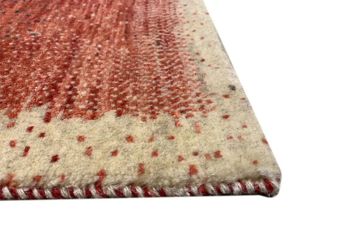 Corner of the Gabbeh rug with a reddish-brown all-over pattern and dense wool texture