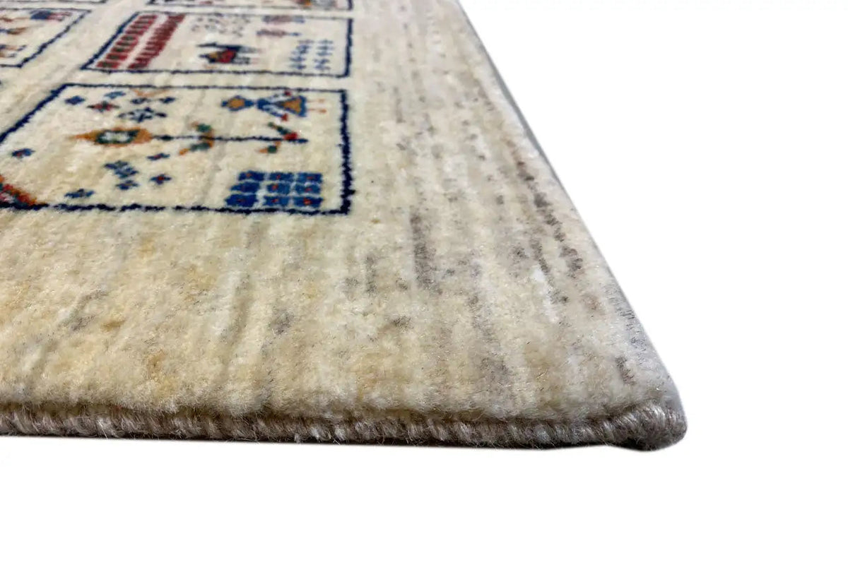 Gabbeh rug corner: beige pile with an outlined blue border pattern