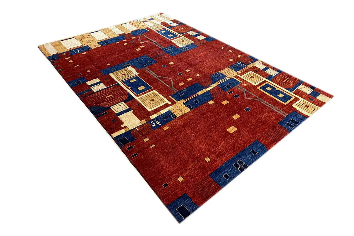Lori Gabbeh rug with a geometric patchwork pattern in red, blue, and cream