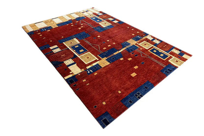 Lori Gabbeh rug with a geometric patchwork pattern in red, blue, and cream