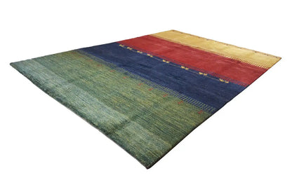 Gabbeh rug diagonal view: green area, dark blue stripes, red zone and yellow