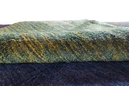 Close-up of a Gabbeh rug: mottled greenish-blue wool surface
