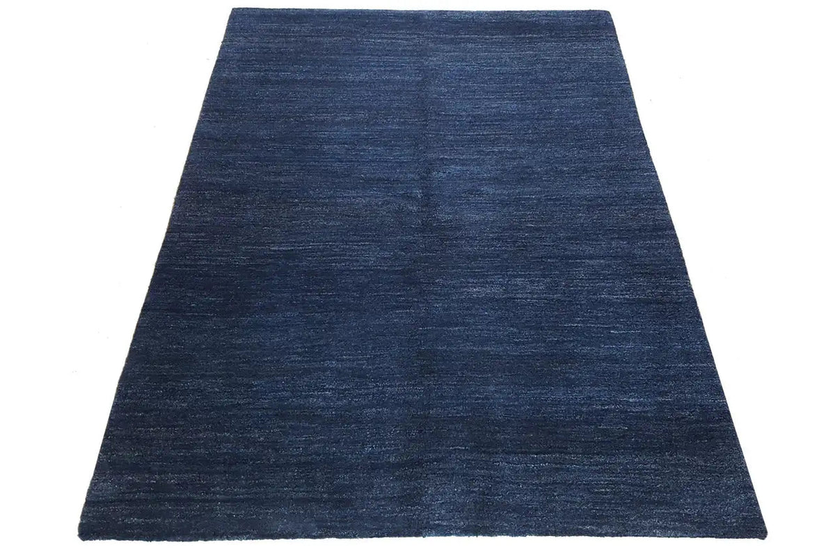 Blue gabbeh rug with a fine heathered texture, rectangular