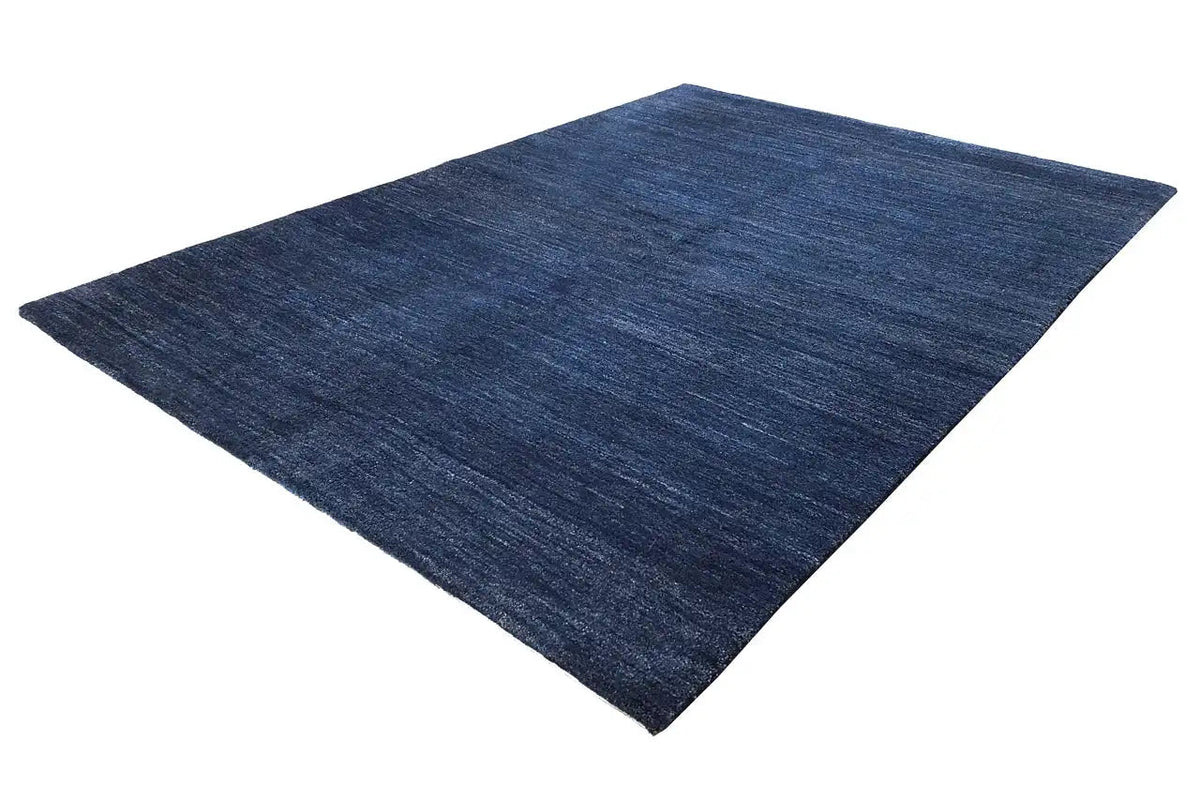 Blue carpet with a mottled texture, rectangular, laid diagonally