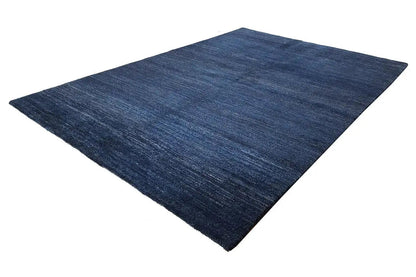 Blue rug with a marled surface, rectangular and appearing flat-woven
