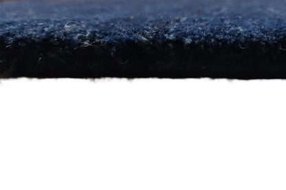 Carpet detail at the edge: short dark pile, blue-gray blended look