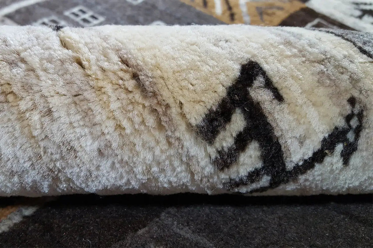 Gabbeh rug: plush pile with a black and beige pattern and a short, dense texture.